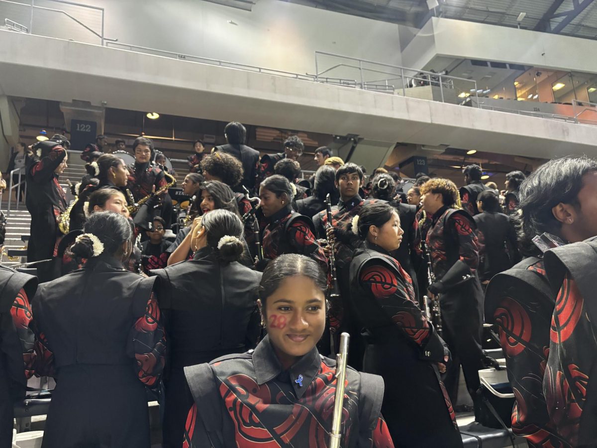 Freshman Emma George smiles in hopes for a great half time show and football game. 