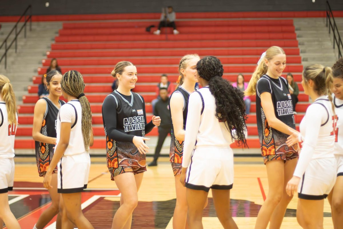 The game was a hard one, with the winner coming out on a top by a narrow margins of four points. The Redhawks greet their opponents after the game. 