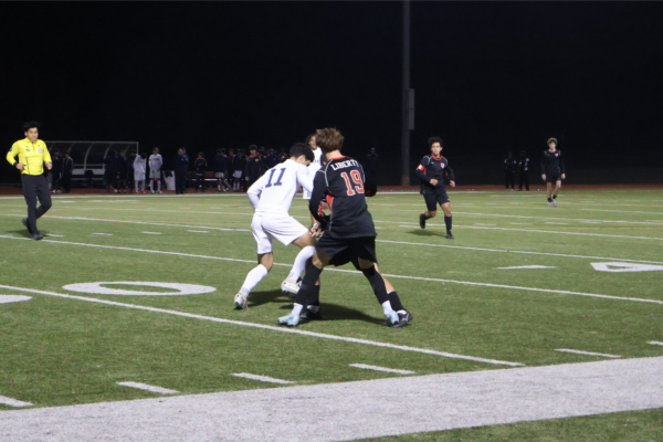 Sophomore Pierce McCord battles for the ball against the Centennial Titians Tuesday.