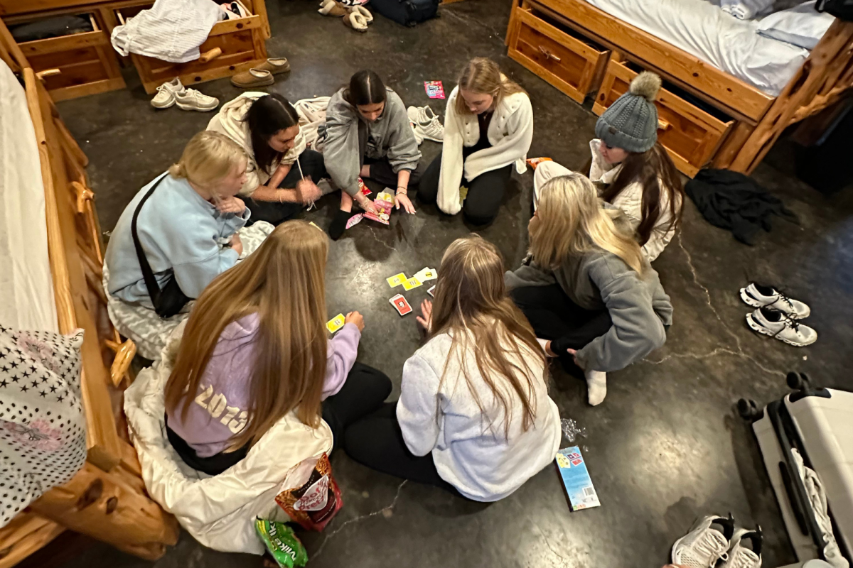 Campers gather around to play board games during free time. 