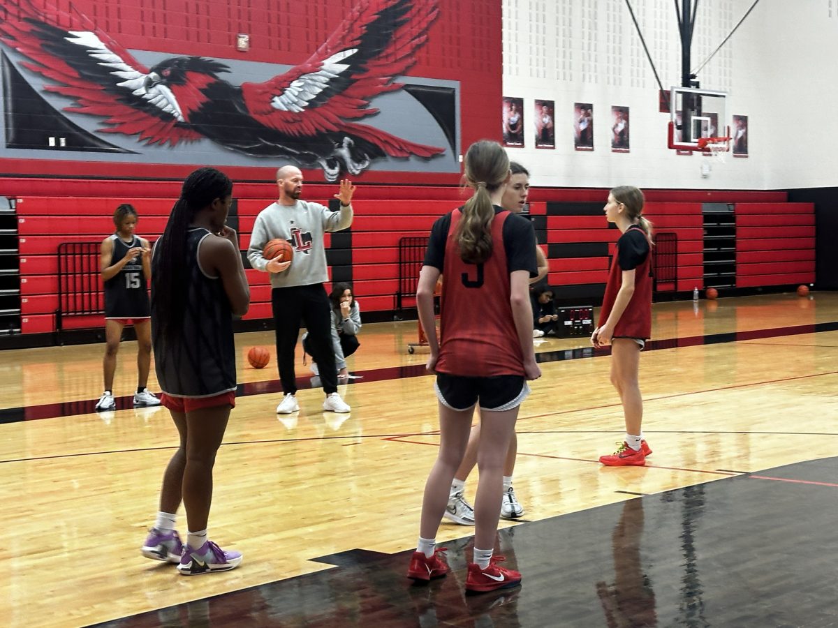 As players look on during practice, head coach Ross Reedy instructs the team.

The Redhawks enter the playoffs against Wakeland on Monday as the two-time defending 5A state champions. 