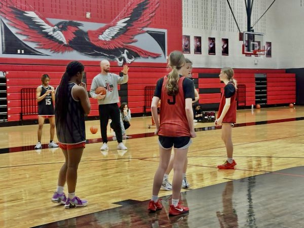 As players look on during practice, head coach Ross Reedy instructs the team.

The Redhawks enter the playoffs against Wakeland on Monday as the two-time defending 5A state champions. 