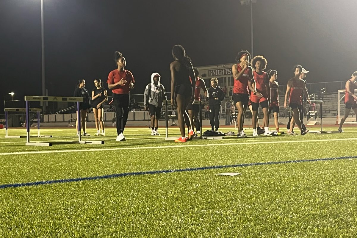 Track and field athletes warm up on the infield at Independence for Thursday's practice meet against the Knights. Although the meet wasn't score, the Redhawks won a majority of the events according to team members. 