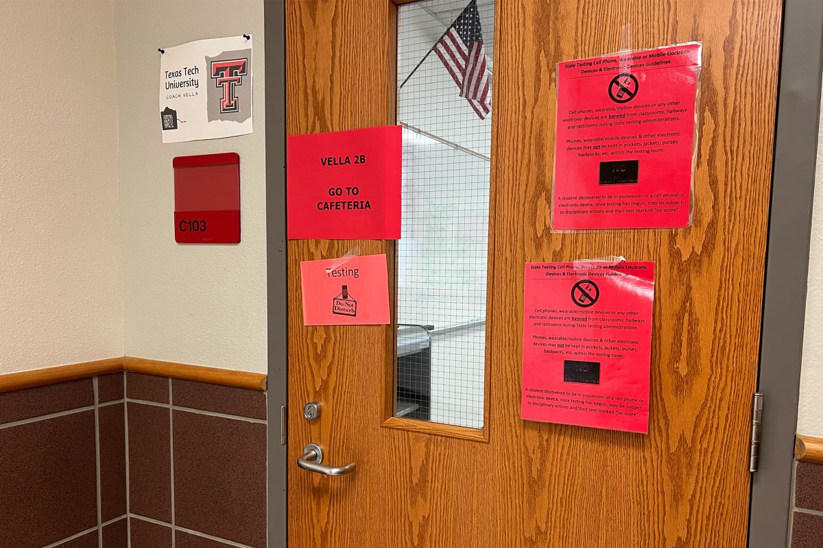 Red signs are taped to doors throughout campus for Wednesday's SAT testing day for juniors. Freshmen, sophomores, and seniors have a late arrival time of 12:15 at which point they will go to their 2nd period class.