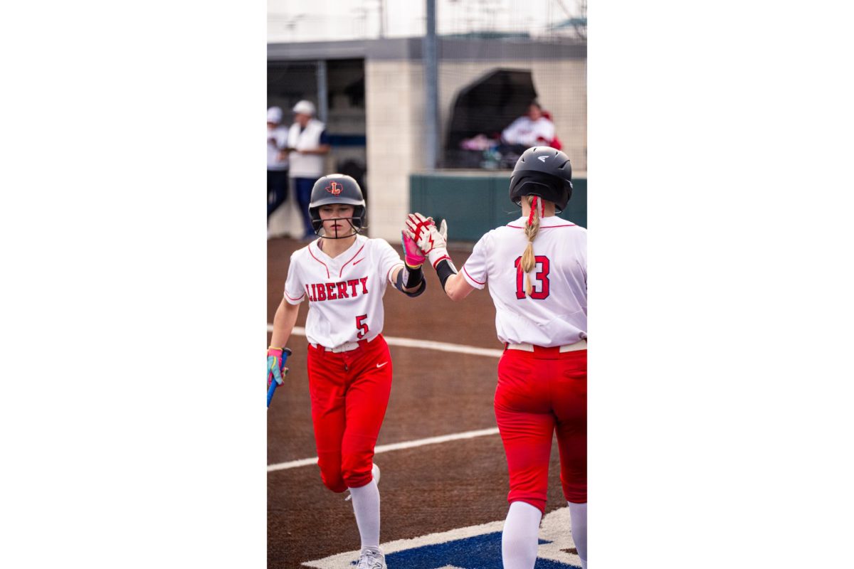 Freshman pitcher Beckley Baumgart (5) and senior utility player/pitcher Hanson (13)