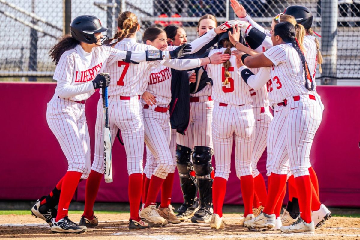 The softball team gathers around freshman pitcher Beckley Baumgart (#5) to celebrate another home run.

With five home runs on the sesason, Baumgart is just two away from the school season record of seven. 
